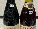 two bottles of wine sitting next to each other on a counter
