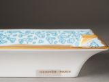 a close up of a white bowl with a blue and gold border