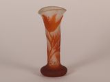 a glass vase with an orange and white design on it