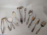 a lot of spoons and forks that are on the table