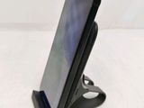 a close up of a cell phone on a stand on a table