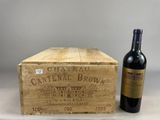 two bottles of wine sitting next to a wooden box