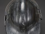 an old fireman ' s helmet on a black background