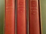 three books in a box sitting on a table next to each other