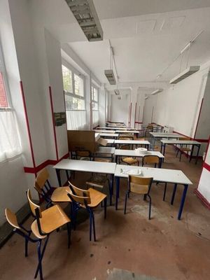 many empty desks and chairs in this classroom