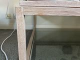 a small wooden table with a blue ball on top of it