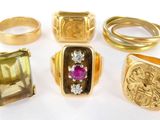 several different types of gold rings and rings on a white surface