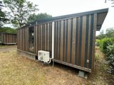 an image of a tiny house that is in the grass