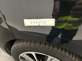 a reflection of a man standing on the side of a car