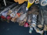 many rolls of fabric on the floor next to each other