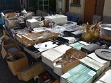 many boxes of items on a table outside of a house