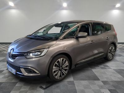 a grey car parked in a room with a checkered floor