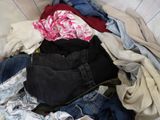 a pile of clothes that is sitting in a basket