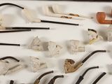 many different types of smoking pipes and pipes on the table