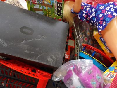 a doll that is sitting in a pile of toys