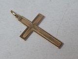 a close up of a gold cross on a white surface
