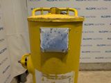 a yellow fire hydrant that is in front of a wall
