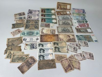 many different types of paper money laid out on a table