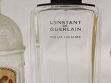 two bottles of perfume sitting next to each other on a white surface