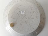 a white plate with a brown spot on it