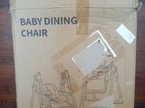 a baby dining chair in the box on the table