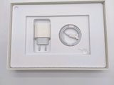 a white box with a charger and a cable in it
