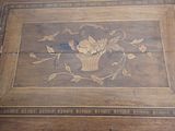 a picture of a wooden table with a flower design on it