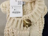 a picture of a sweater with a tag on it