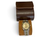 brown leather watch case with a watch inside of it on a white surface