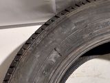a close up of a tire on the side of a white car