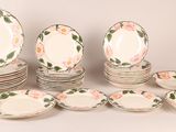 a lot of plates that are sitting on a table
