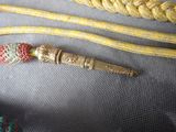 a yellow rope with a gold bead on top of it