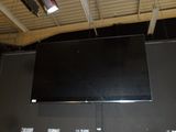 a flat screen tv mounted on a wall in a room