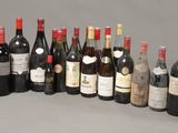 many bottles of wine that are lined up on the table