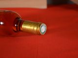 a bottle of wine sitting on a red table cloth