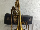 an old brass trumpet and other musical instruments sitting on a table