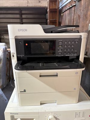 a stack of printers and a printer sitting on top of each other