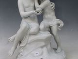 a statue of two children sitting on a rock