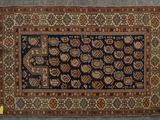 a blue and brown rug with a design on it