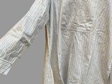 an old shirt hanging on a hanger on a gray background