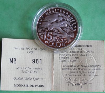 a silver coin with a picture of a bird on it