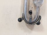a silver spoon and fork hanging on a wall