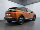 the rear end of an orange suv parked in a garage