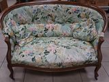 a couch that is sitting in a room with tile flooring
