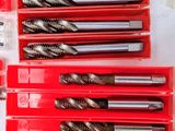 a close up of a bunch of drill bits in a box