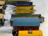 several toy trains are lined up in a row on a white surface