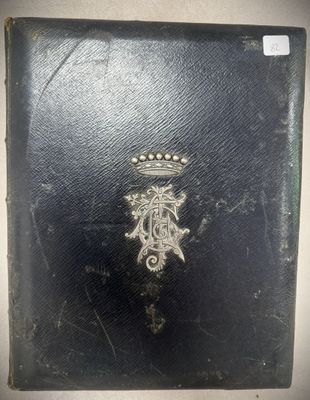 un vieux livre orné d'une couronne, posé sur une table
