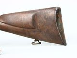 a small wooden object that is on a white surface