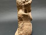 an ancient statue of a woman holding a baby in her arms