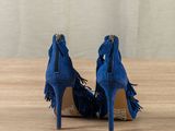 blue sued high heels with tassels and zippers on the toes